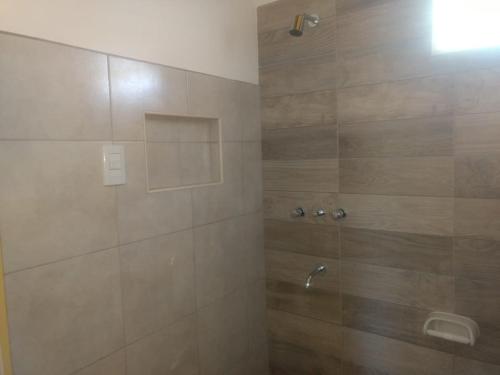 a bathroom with a shower with a glass door at View Point Apart Pino in Villa Giardino