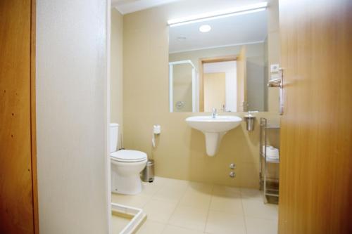 a bathroom with a toilet and a sink at HI Vila Nova de Cerveira - Pousada de Juventude in Vila Nova de Cerveira