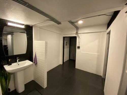a bathroom with a sink and a mirror at Backpack Hostel in Chiang Rai