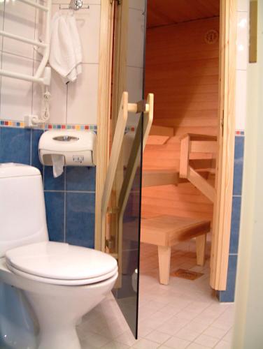 a bathroom with a toilet and a staircase at Spa Hotel Rauhalahti in Kuopio