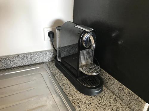 a hair dryer sitting on a counter next to a door at Appartement haut standing calme + piscines + WIFI in Asilah
