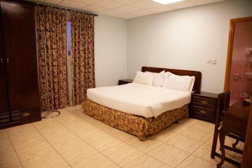 מיטה או מיטות בחדר ב-Seven Garden Alhada Suites