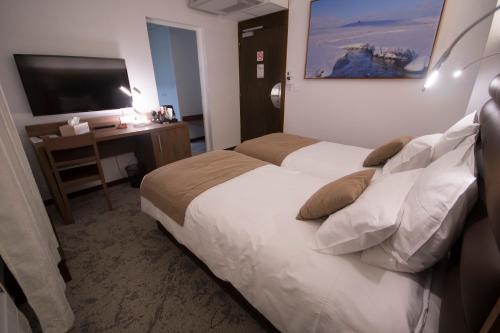 Postel nebo postele na pokoji v ubytování Hôtel Bastide