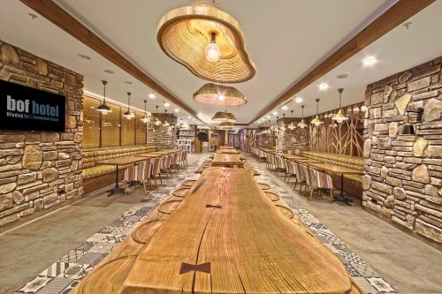 a long table in a restaurant with tables and chairs at Bof Hotels Uludağ Ski&Luxury Resort All Inclusive in Uludag