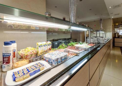 a buffet line in a restaurant with food at Hotel Aurum Family "A" in Hajdúszoboszló