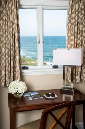 a desk with a window with a view of the ocean at Union Bluff Hotel & Meeting House in York Beach