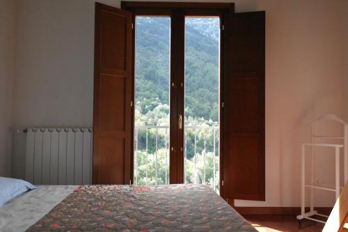Schlafzimmer mit einer großen Glastür mit Aussicht in der Unterkunft Casa Vacanze sul Gizio in Pettorano sul Gizio
