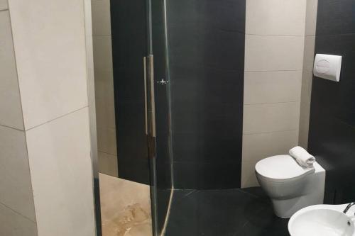 a bathroom with a toilet and a glass shower at Casual Life Suite in Reggio di Calabria