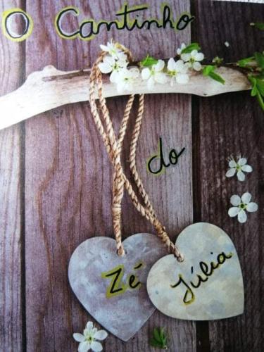 two hearts on a wooden table with a wooden cross at Cantinho do Zé e da Júlia in Lagos