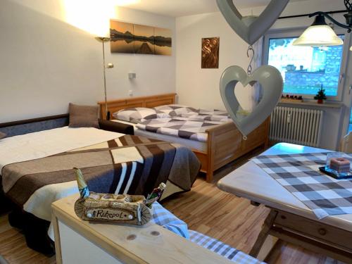 a room with two beds and a heart on the wall at Ferienwohnung Ruhepol in Bichel