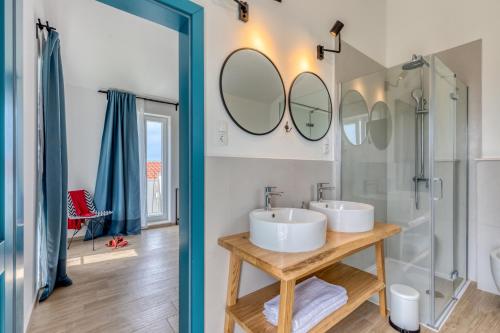 a bathroom with two sinks and a shower at Villa Vela Muline - 8 plus 2 guests - heated pool in Ugljan