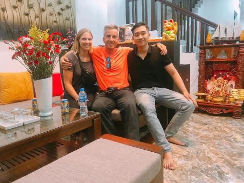 a man and a woman sitting on a couch at Sunny Riverside Homestay in Hoi An