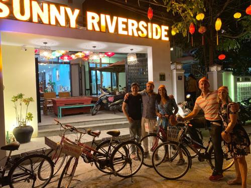 a group of people standing in front of a store with bikes at Sunny Riverside Homestay in Hoi An