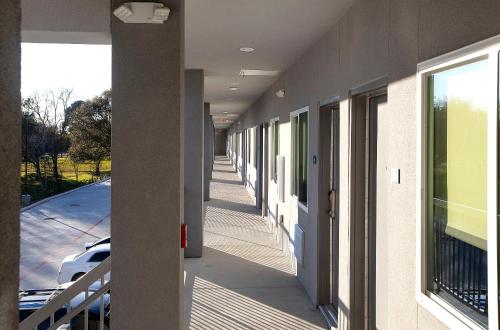 a hallway of a building with a car on the street at Express Inn in Rosenberg