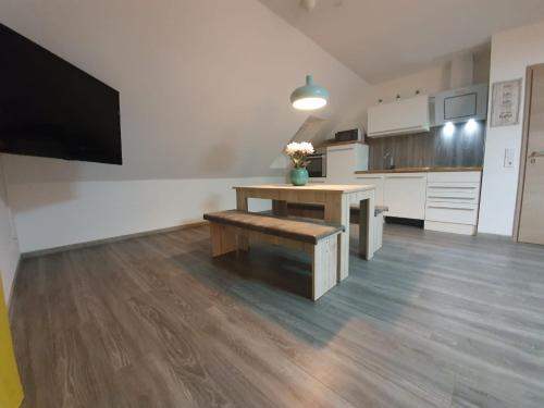 a large kitchen with a wooden table and a bench at Haus Schneider in Winterberg