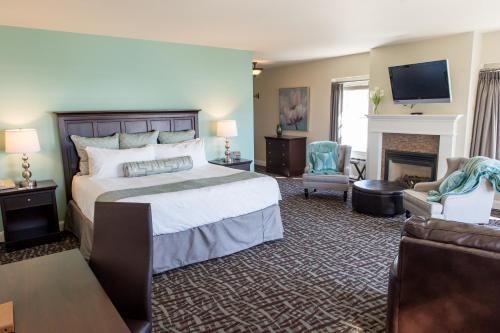 a large bedroom with a bed and a fireplace at Union Bluff Hotel & Meeting House in York Beach