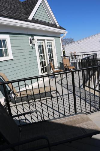 a deck in front of a house with chairs at Union Bluff Hotel & Meeting House in York Beach