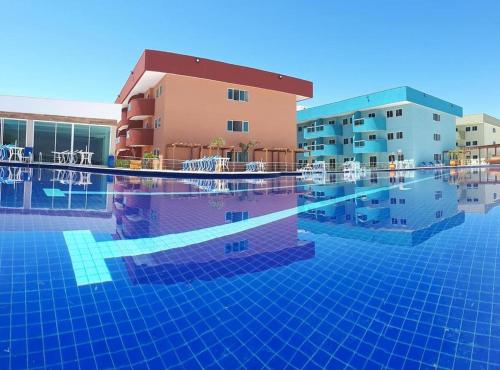 a swimming pool in front of a building at Arraial do cabo golden Lake in Arraial do Cabo