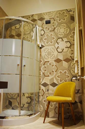a shower with a yellow chair in a bathroom at La Torre del Tempo in Turi