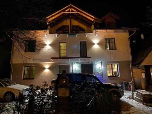 a house with a car parked in front of it at night at Penzion Gerle in Černý Dŭl