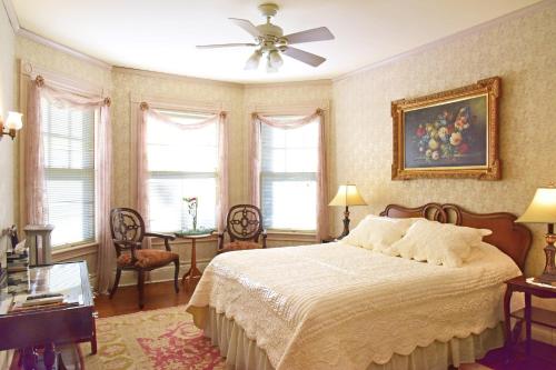 a bedroom with a bed and a ceiling fan at Wainwright Inn in Great Barrington