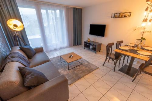 a living room with a couch and a table at Seehüsli near Interlaken, Grindelwald and Lauterbrunnen in Därligen