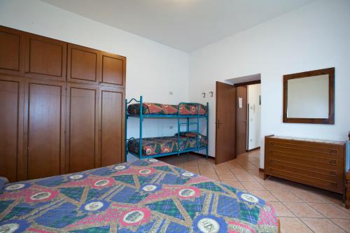 a bedroom with a bed and two bunk beds at Villa Presolana in Castione della Presolana