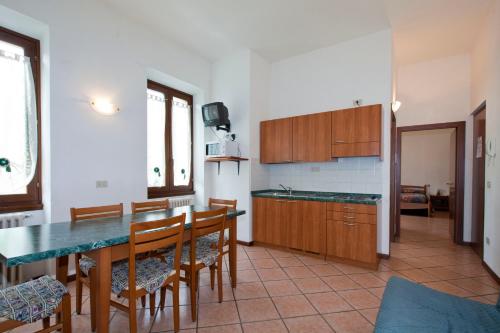 a kitchen with a table and chairs in a room at Villa Presolana in Castione della Presolana
