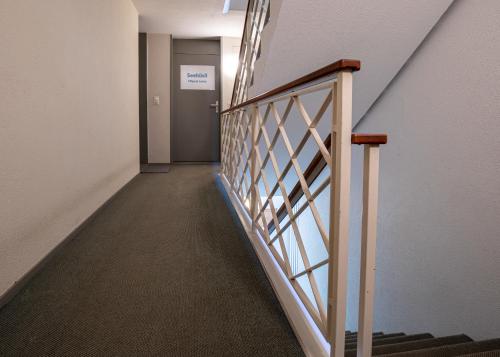 a hallway with stairs in a building at Seehüsli near Interlaken, Grindelwald and Lauterbrunnen in Därligen