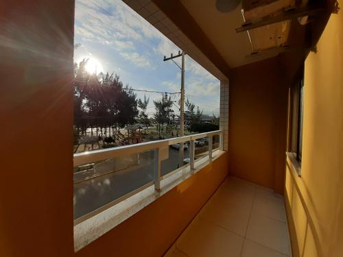 a window in a room with a view of a balcony at Lebanon Praia Hotel in Tramandaí