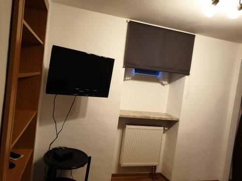 a flat screen tv on a wall in a room at Appartement Schepper's in Trier