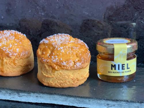 two buns and a jar of honey on a counter at Fairmont Le Manoir Richelieu in La Malbaie