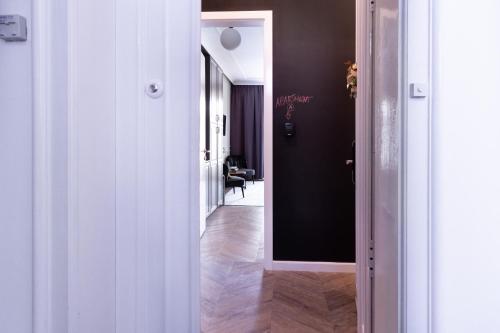 a hallway with a black wall and a white door at Tesla Design Apartments Zagreb in Zagreb