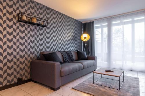 a living room with a couch and a table at Seehüsli near Interlaken, Grindelwald and Lauterbrunnen in Därligen