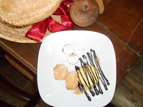 a white plate with some food on a table at Agriturismo La Casa Nei Boschi in Colderù