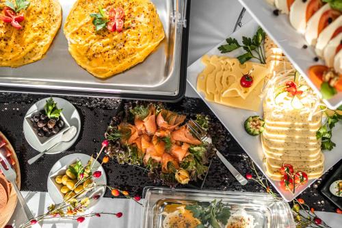 a table topped with plates of food on top at EE Hotel in Kassel