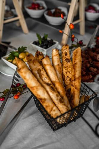 a basket of food sitting on a table with plates of food at EE Hotel in Kassel