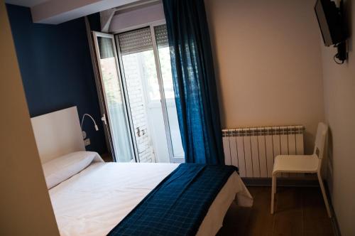 Postel nebo postele na pokoji v ubytování Hostal Mónaco