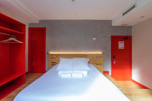 a bedroom with a large bed and a large window at Ok Hostel Madrid in Madrid
