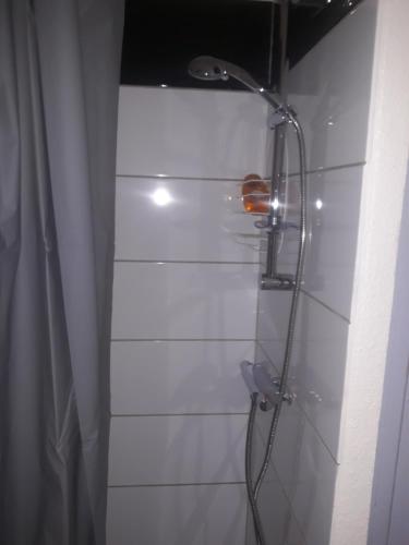 a shower with a shower head in a bathroom at Studio les deux alpes Résidence le Pluton B84 WIFI in Les Deux Alpes