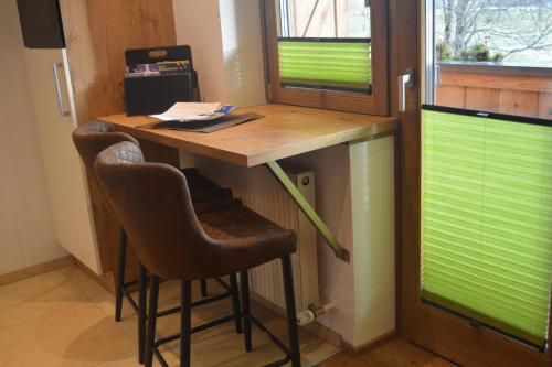 a desk in a room with two bar stools at Ramseiderhof in Saalfelden am Steinernen Meer