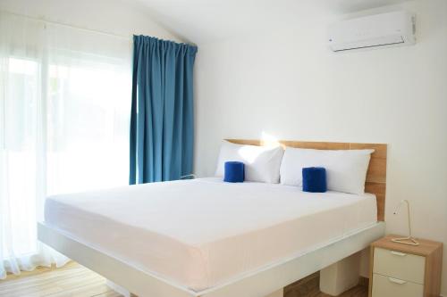 a large white bed in a room with a window at Tropical Casa Laguna in Cabarete
