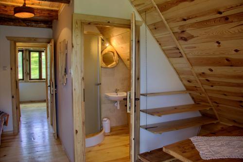 a bathroom with a stairs leading to a sink at DoliAnna in Krasnobród