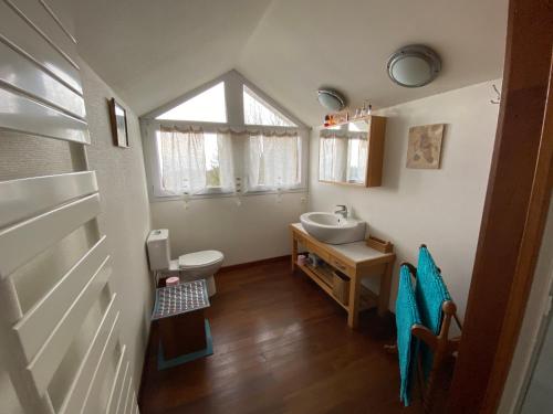 a bathroom with a sink and a toilet and a window at le montanet in Thollon