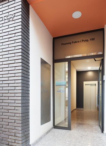 a hallway of a building with a sign on the side of it at Mediterranean Barcelona Apartments in Barcelona