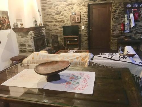 a room with a table with a wooden bowl on it at Casa da Zeza in Negreda