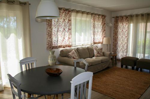 a living room with a table and a couch at Encosta da Camarinha in Ferreira do Zêzere