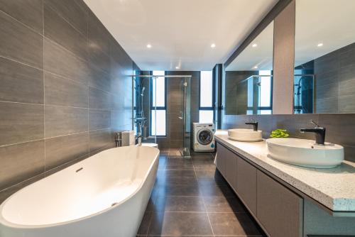 a bathroom with two sinks and a large tub at WGS Suites at KLCC in Kuala Lumpur