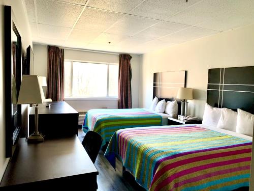 um quarto de hotel com duas camas e uma janela em Tappan Zee Hotel em West Nyack