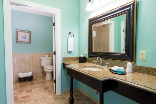 a bathroom with a sink and a toilet and a mirror at Union Bluff Hotel & Meeting House in York Beach